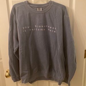 “your brokenness is welcome here” sweatshirt